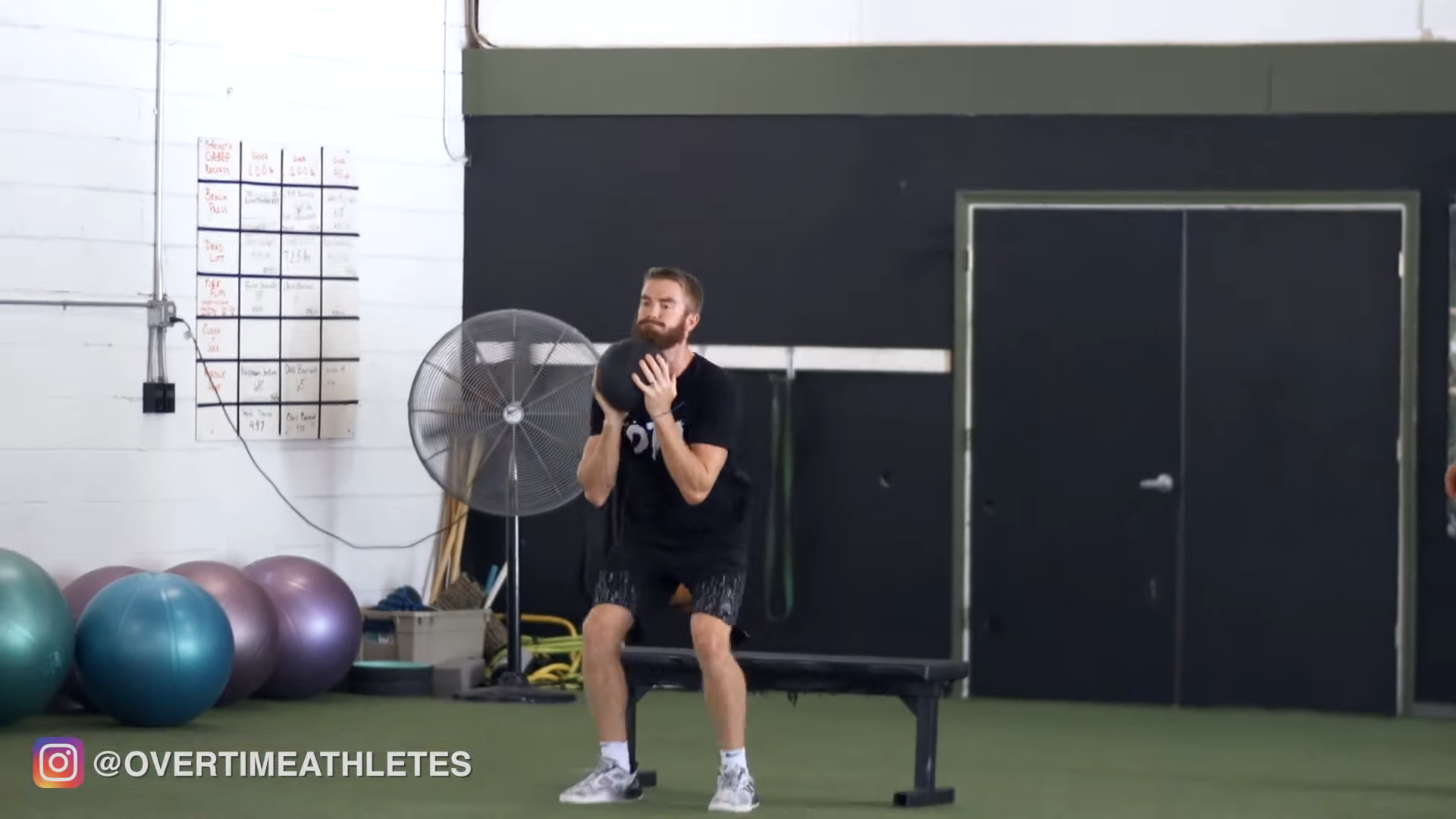 Athlete performs med ball squat