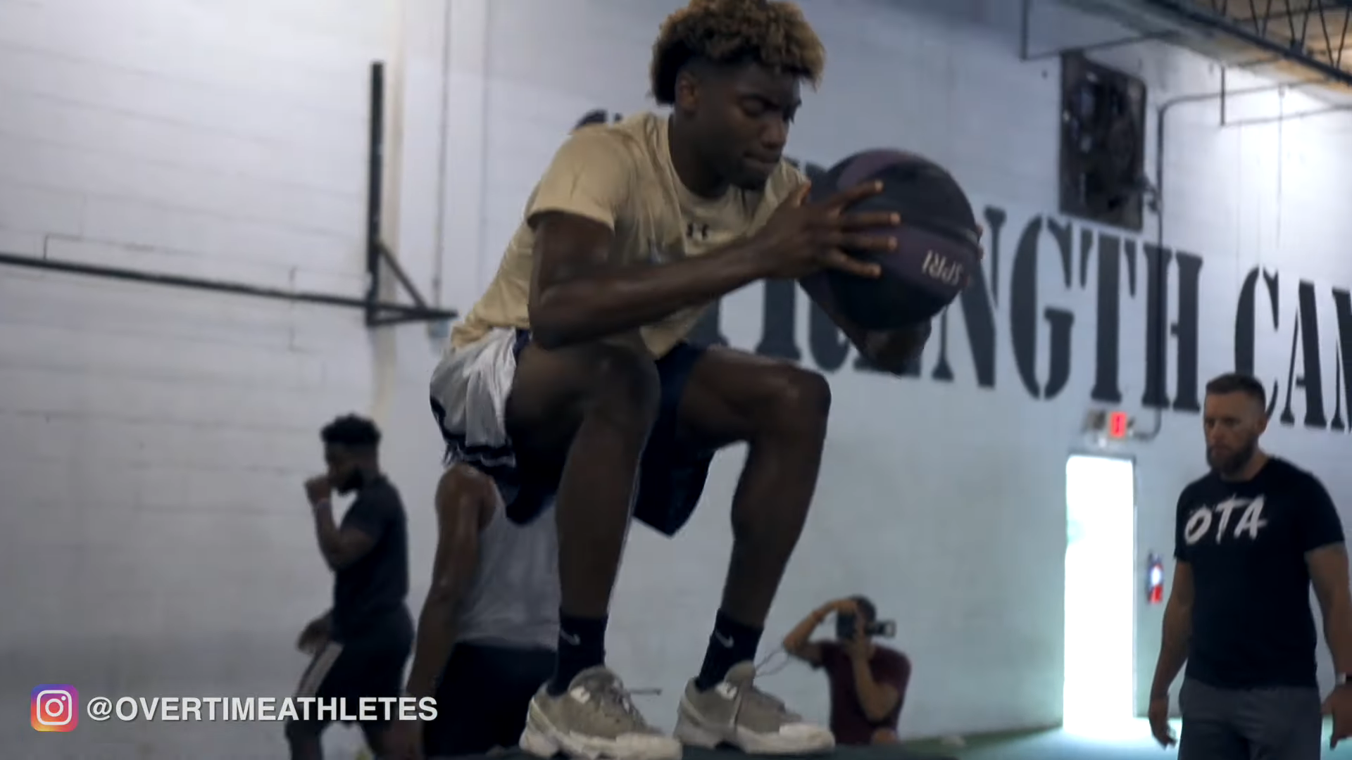 Athlete Performs weighted box jumps