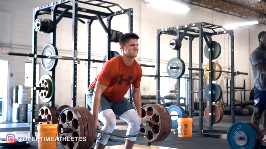 athlete performs trap bar deadlift