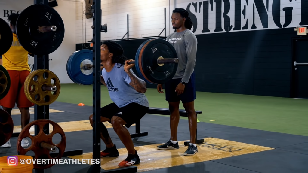 Athlet Performs Barbell Squat