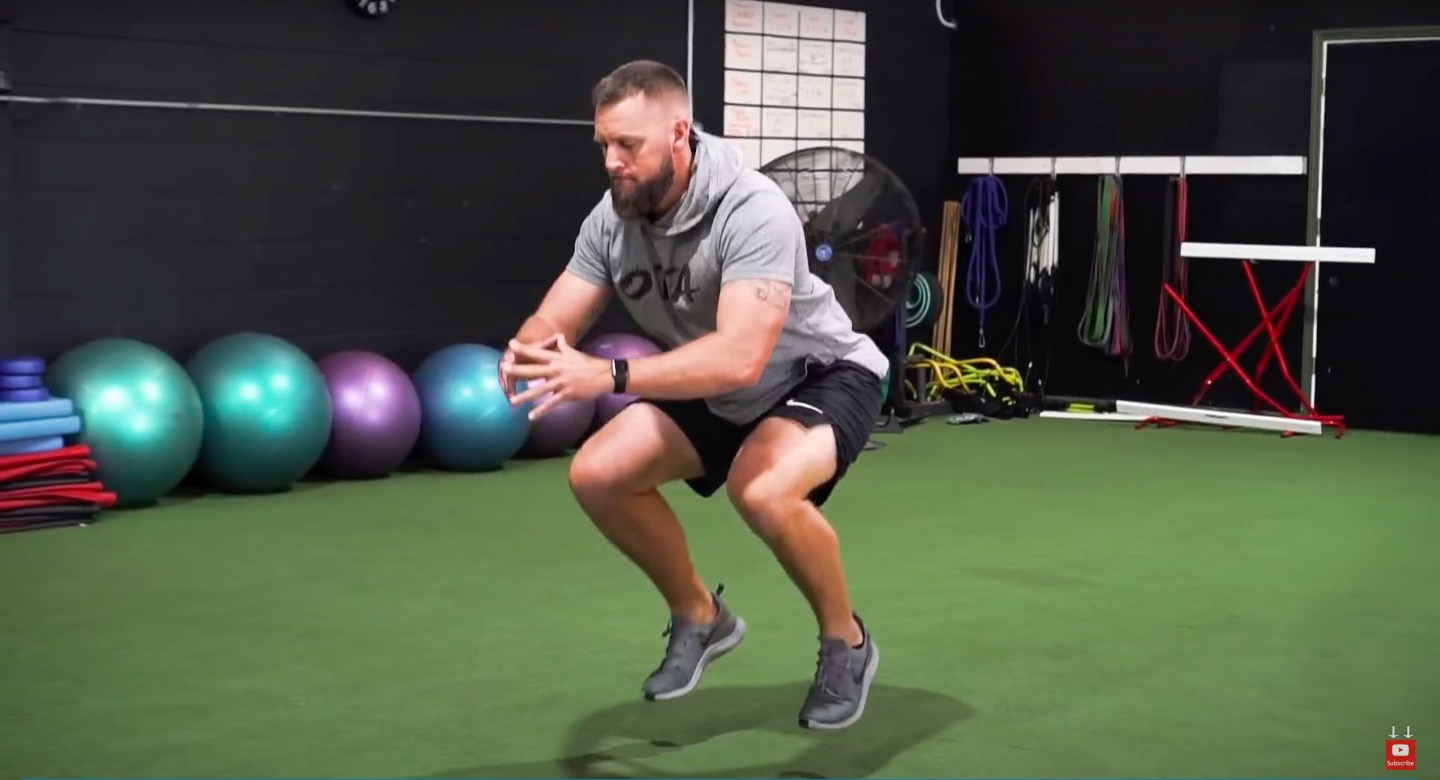 Athlete performs low squat foot jumps