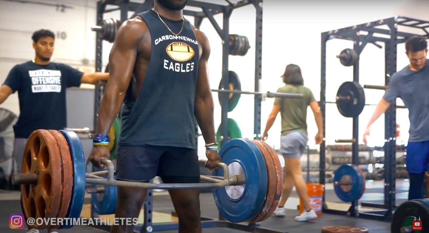 athlete performs trap bar deadlift